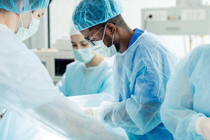 young talented afro doctor making a surgeon.close up side view photo
