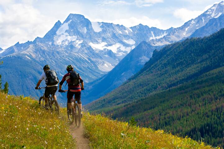 Two male mountain bike riders enjoy a cross country trail in British Columbia, Canada.