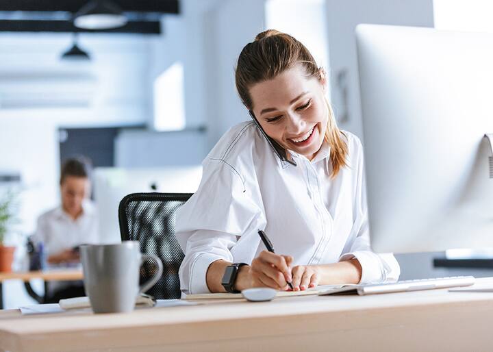 Woman smiling taking notes