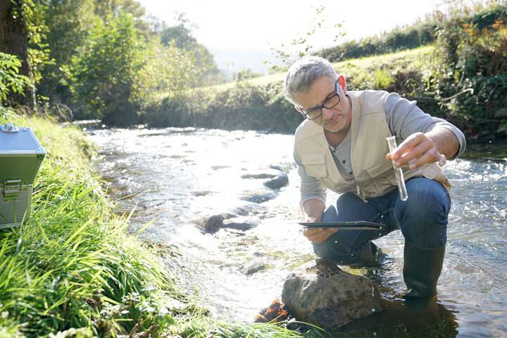 Biologist testing water quality of river