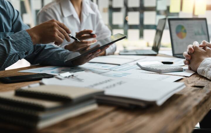 Asian business adviser meeting to analyze and discuss the situation on the financial report in the meeting room.Investment Consultant,Financial Consultant,Financial advisor and accounting concept.