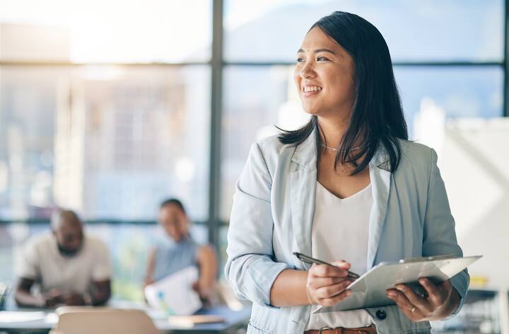 Asian woman in office with clipboard, smile and leadership with business meeting schedule in professional space. Workshop, management and happy businesswoman with checklist, mockup and confidence