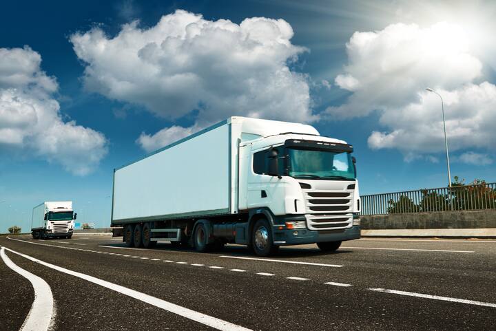 White truck is on highway - business, commercial, cargo transportation concept, clear and blank space on the side view