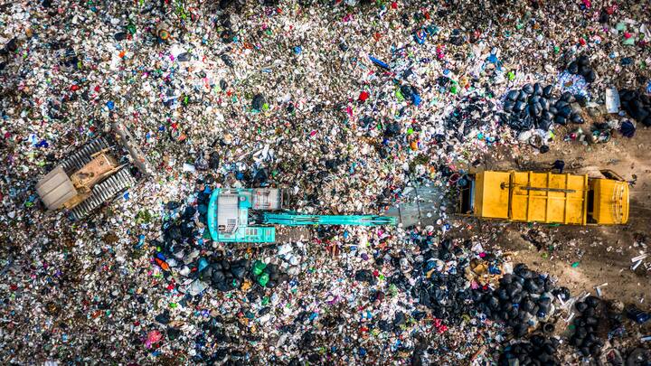 Garbage pile  in trash dump or landfill, Aerial view garbage trucks unload garbage to a landfill,  global warming.