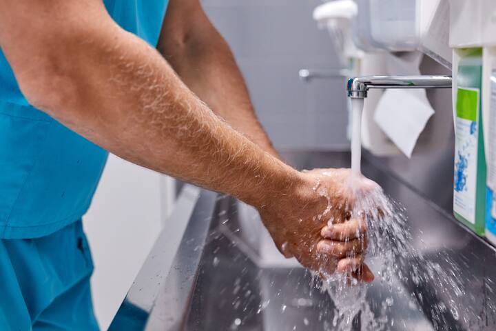 male doctor wash hands before surgery operation, clean the dirt. in sterile operating room