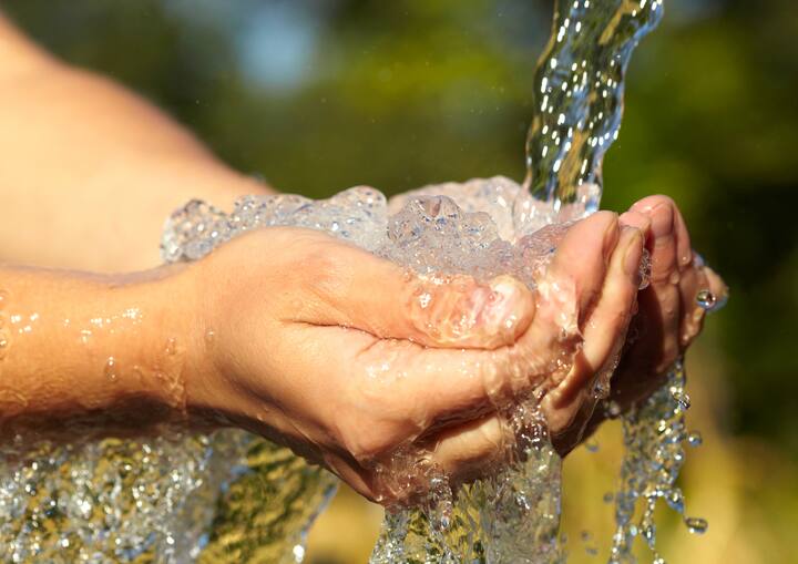 Woman's hands with water splash 