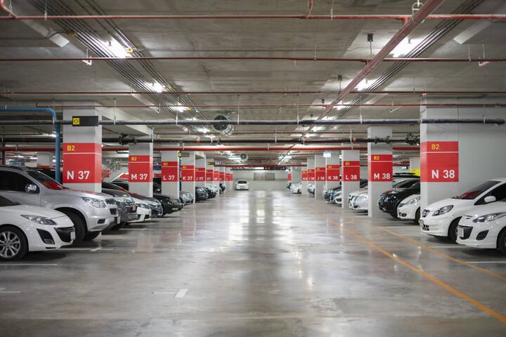 Blurred image/ Parking garage - interior shot of multi-story car park, underground parking with cars.
